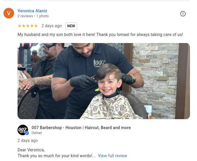A kid smiling while having a haircut at 007 barbershop